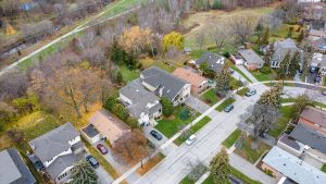 Aerial view of a suburban neighborhood with houses and trees in autumn.