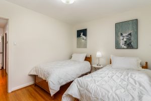 Cozy bedroom with two twin beds and minimal decor.