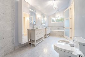 Bright, modern bathroom with marble walls and floors.