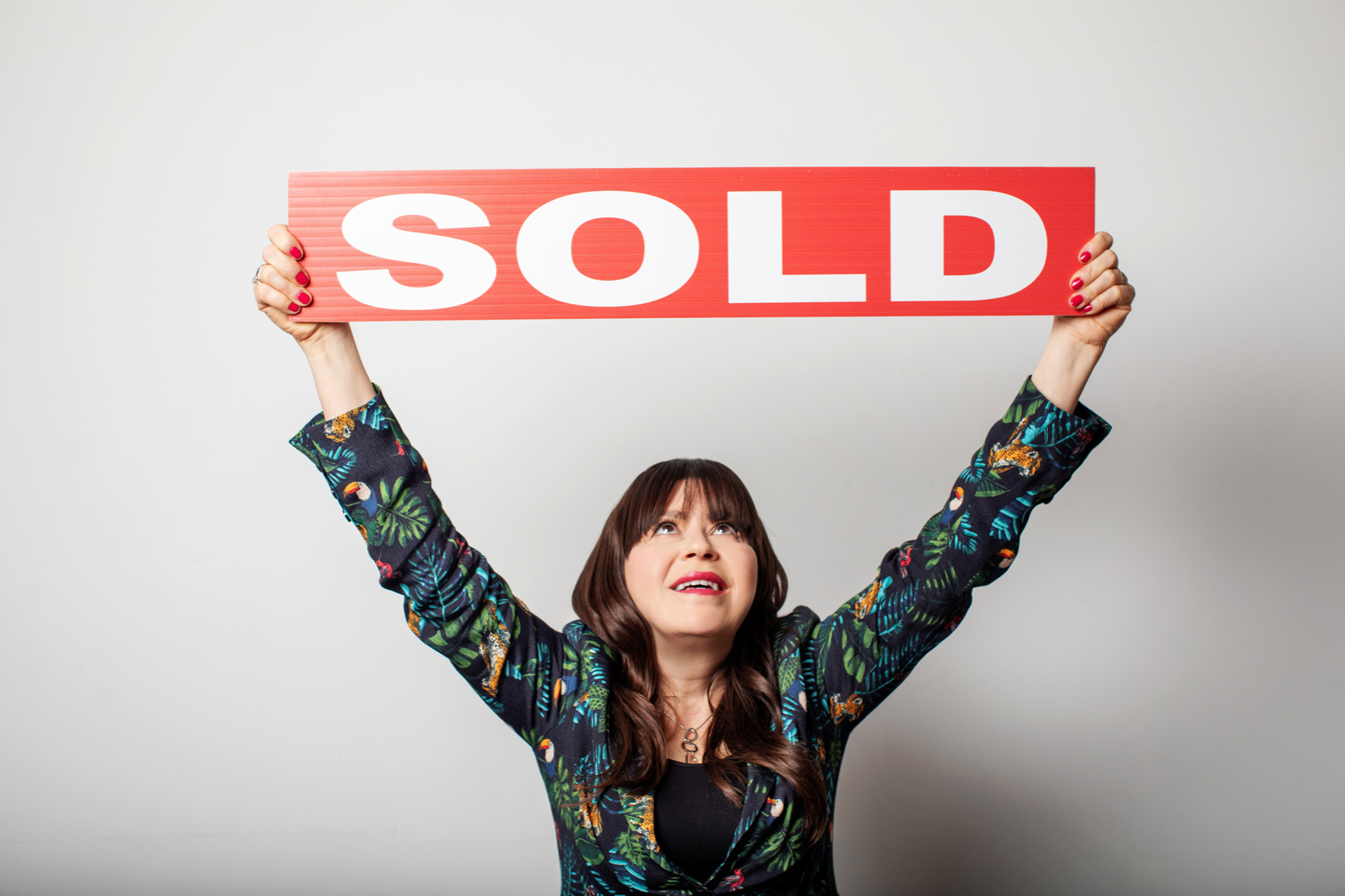 Eringate Real estate agent Leslie Brlec holding up a sold sign